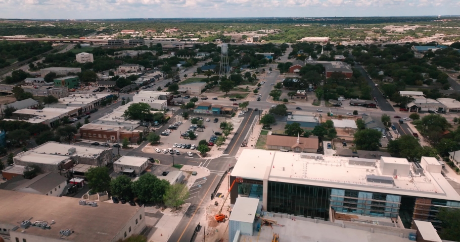 Downtown Round Rock Texas Aerial drone orbit over Main Street water tower on sunny summer day in 4k