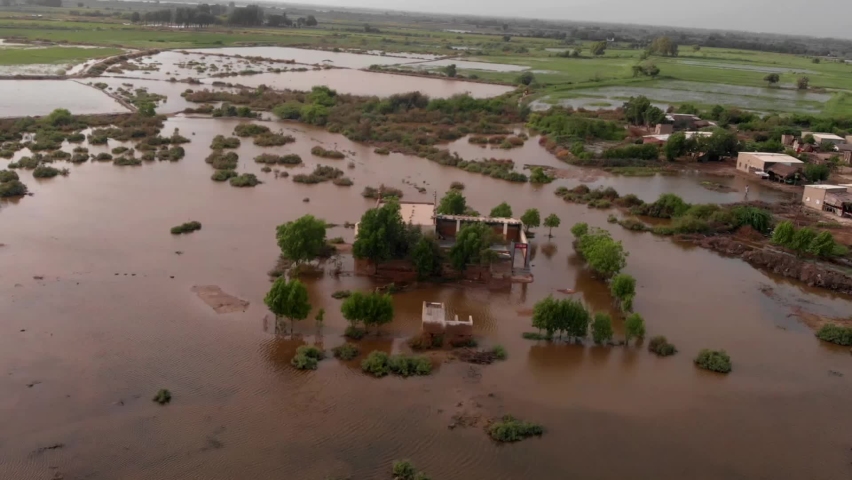 Drone footage from Sindh, Pakistan shows a farm being submerged by floodwaters and having all of its vegetation destroyed. Royalty-Free Stock Footage #1094085905