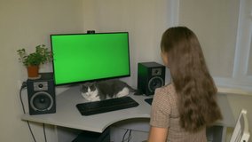 Girl looks at the screen, gets up, rejoices and dances. Chromakey on computer screen.

Video with a chroma key on the screen to insert any video or image.
