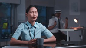 Asian woman discussing project online working in office with augmented reality technology. Entrepreneur have video conference using holographic screen