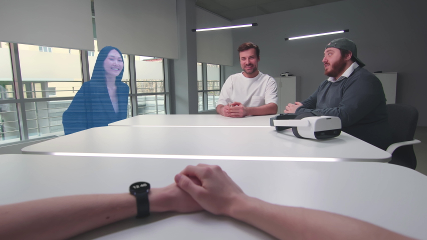 Holographic asian woman join meeting online with startup team. Cropped shot of hands push button on smartwatch and disconnect asian colleague from online conference - Powered by Shutterstock - Get 15% off with code: PIKWIZARD15