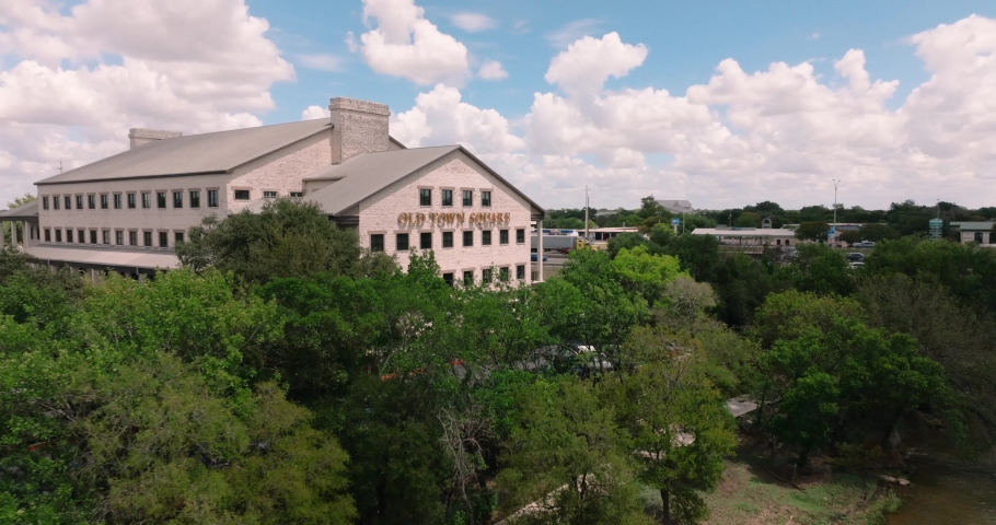 Old Town Square Office Building in Round Rock Texas Memorial Park Chisholm Trail aerial orbit on sunny day in 4k