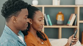 Happy, love and couple on a phone streaming a online subscription service entertainment movie, tv series or video. Married black woman and man relax in home living room sofa on social media together