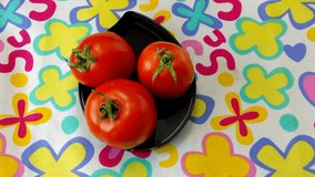 Tomatoes on a beautiful colorful background, illustrated video from the top, with 4k resolution