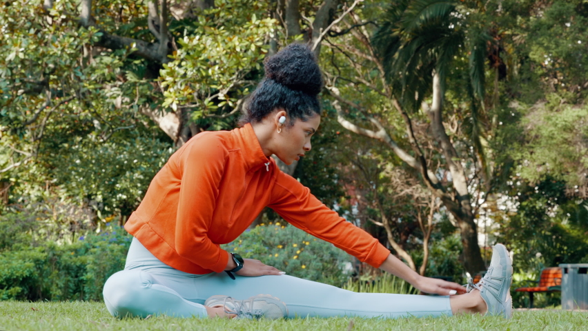 Black woman stretching leg in the park for fitness, health and wellness before a run. Exercise, sports and female athlete warm up training outside or in nature for mobility, flexibility and strength. Royalty-Free Stock Footage #1094099291