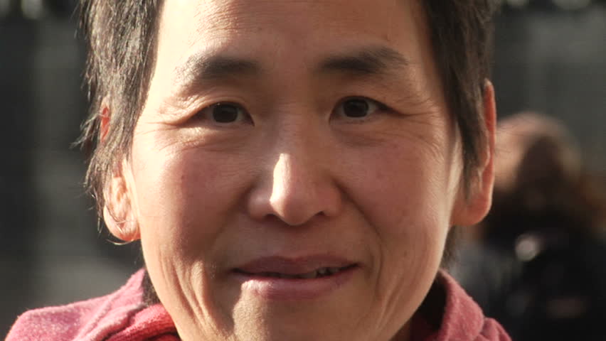Portrait shot of an Asian woman.  Urban setting.