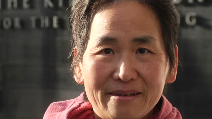 Portrait shot of an Asian woman.  Urban setting.