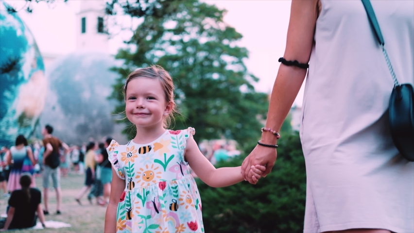 Happy family. People have picnic in the park. Mom in park on green grass play with children. Daughter and son at a picnic in park. Family with children on the grass in park. Children play