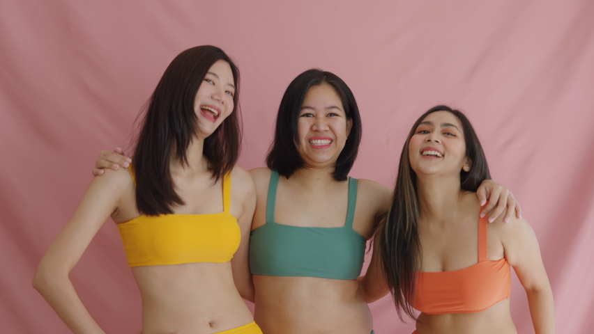 Diverse group of asia people lady show self love smile look at camera dance in studio model photo shooting. Happy proud of woman power plus size chubby fat posing and slim skinny figure type shape.