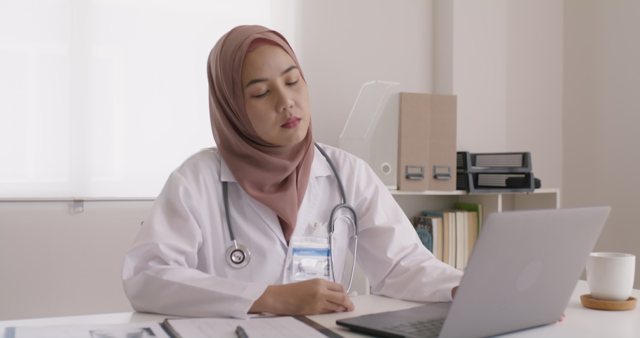 Young islam asia people sit work on desk at clinic office sad stiff neck stress tired long care online telehealth teleconsult telemedicine. Staff worker pain close face massage eyes end finish job. Royalty-Free Stock Footage #1094123795