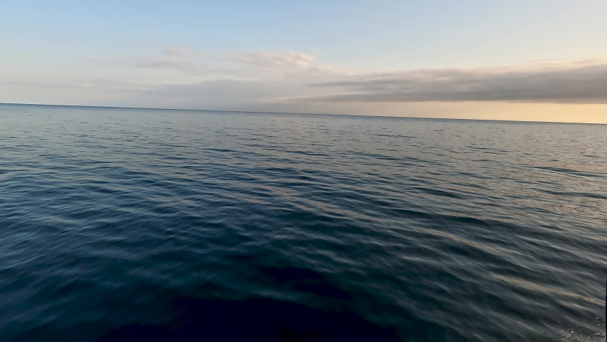 Gliding through the blue lake water, taking off from the Northern shore of the Upper Peninsula of Michigan. Views of the boats wake and evergreen trees in their pristine natural untouched environment.