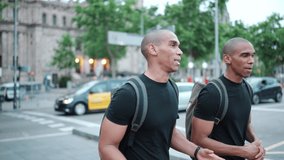 Two pretty bald African brothers talking and walking on the street outdoors - Powered by Shutterstock - Get 15% off with code: PIKWIZARD15