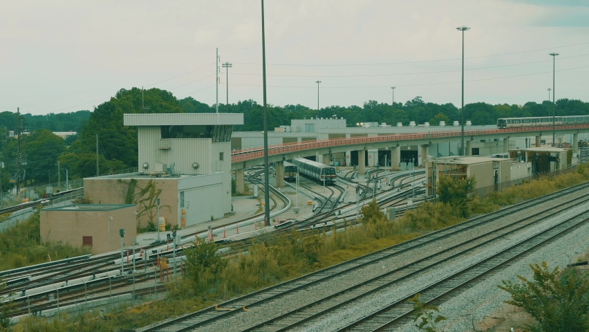 A Train Passes By A Train Station On A Cloudy Day