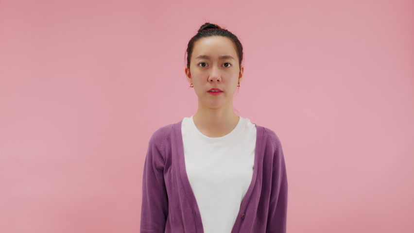 WHY! HOW! Angry frustrated asian woman upset raising hands in indignant expression with suffer face feeling confuse don't understand asking for reasons what's wrong gesture.Isolated on pink background Royalty-Free Stock Footage #1094131757