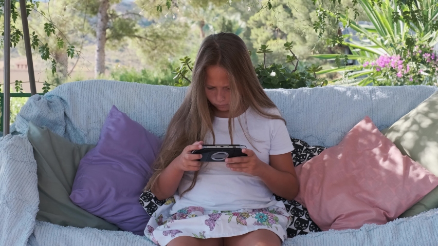 a girl is playing games in a gadget