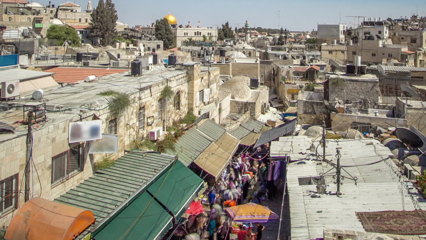 Skyline of the Old City in Jerusalem with historic buildings aerial timelapse, Israel. Middle east. View from Damascus gate with market from above