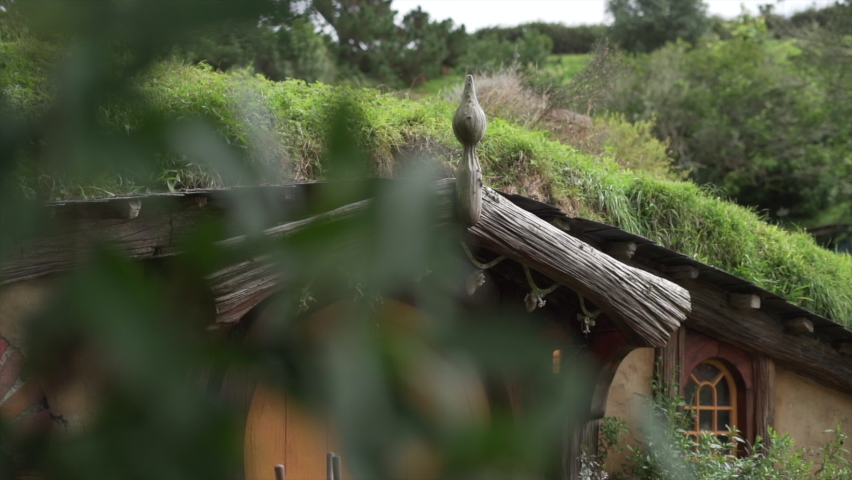 Hobbit house exterior in touristic place in Matamata, New Zelanad - slow motion shot 