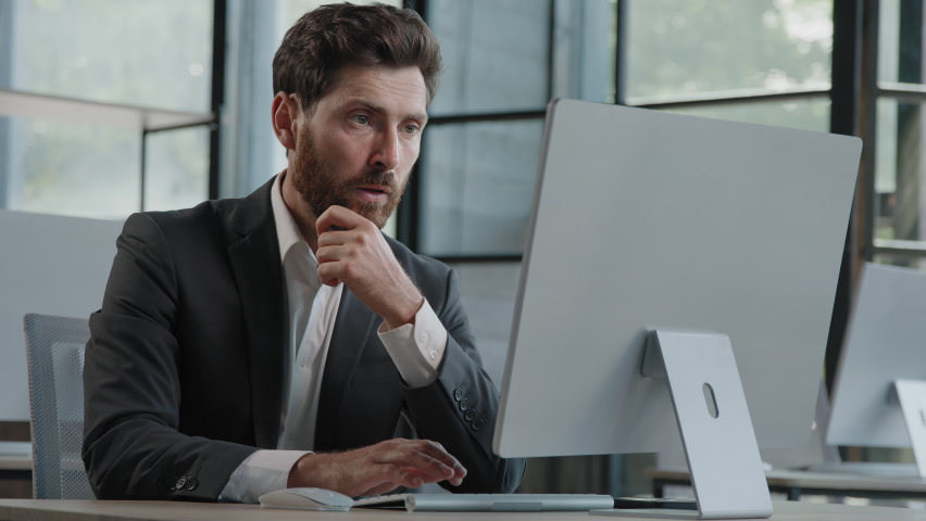 Focused Caucasian bearded adult 40s man CEO company worker manager boss businessman working on computer in office searching solution of problem decide difficult task creating online project thinking Royalty-Free Stock Footage #1094133719