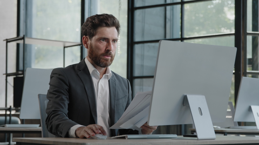Unmotivated tired exhausted burnout adult worker manager businessman sitting in office with paperwork difficult task incorrect data in papers and computer error throws documents holding head with sad | Shutterstock HD Video #1094133723