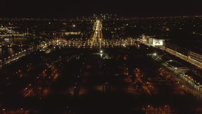 Aerial footage of Place de la Concorde and straight wide Champs Elysees boulevard with Arc de Triomphe. Night view of city landmarks. Paris, France Royalty-Free Stock Footage #1094134171
