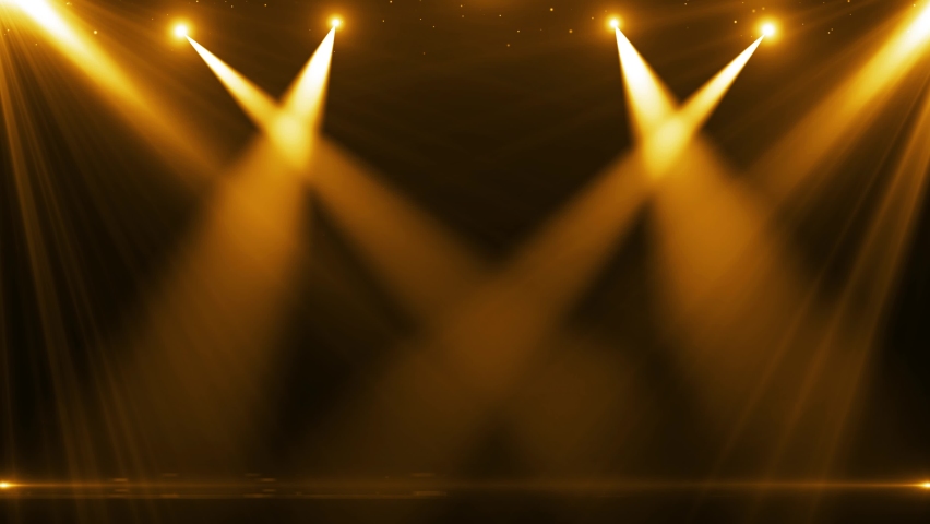The spotlight illuminates the stage background