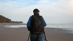 Active backpacker 70s grandfather Scandinavian walk stick exercising at sea beach contemplating nature landscape. Elderly man pensioner patient rehabilitation physical activity outdoor sport back view - Powered by Shutterstock - Get 15% off with code: PIKWIZARD15