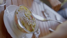 The girl eats a delicious vegetarian soup from vegetables and seeds, slow motion, close-up. vertical video. High quality 4k footage