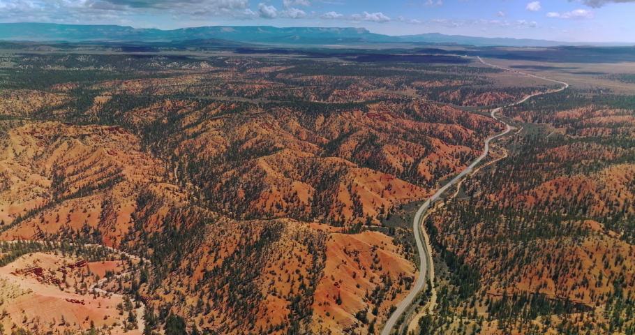 Stunning mountainous panorama of Zion National Park, Utah, USA. Long motorway going through vast territory of park. Aerial perspective.