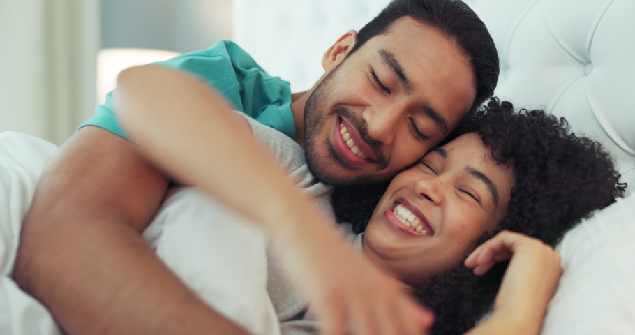 Happy couple, sleep and a hug in bed in the bedroom, house or home. Love, romantic man and woman hugging, cuddle or embrace in the morning in their room with a smile together while being intimate. Royalty-Free Stock Footage #1094146859