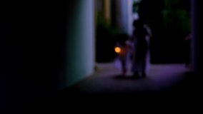 blurry clip of young child and adult spirits, ghostly woman and kid go in creepy tunnel, walks at night, halloween concept, frightening mystical events, friday 13th, horror movie scene