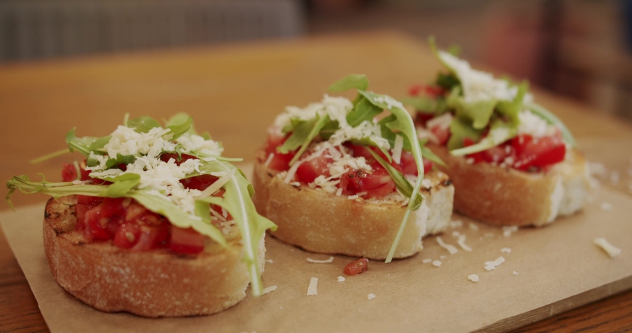 Healthy food and dieting concept. Italian Bruschetta crostini. Healthy, vegan food. Delicious bruschetta sourdough toast with cherry tomatoes, cheese and arugula. traditional italian breakfast brunch