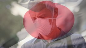 Animation of flag of japan waving over caucasian man wearing face mask in city street. global health precautions during covid 19 pandemic concept digitally generated video.