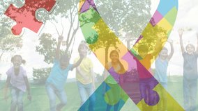 Animation of colourful puzzle pieces creating autism awareness ribbon over schoolchildren. autism, learning difficulties, support and awareness concept digitally generated video. - Powered by Shutterstock - Get 15% off with code: PIKWIZARD15