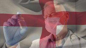 Animation of flag of england waving over doctor wearing face mask and holding vaccine. global medicine, healthcare services during covid 19 pandemic concept digitally generated video.
