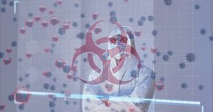 Animation of biohazard icon, virus cells, digital interface over male doctor wearing face mask. global medicine, healthcare and technology during covid 19 pandemic concept digitally generated video.