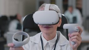 Metaverse industry 4.0 transformation. Mature woman doctor work in augmented reality headset in modern laboratory. Close up portrait of female scientist use vr glasses and joysticks - Powered by Shutterstock - Get 15% off with code: PIKWIZARD15