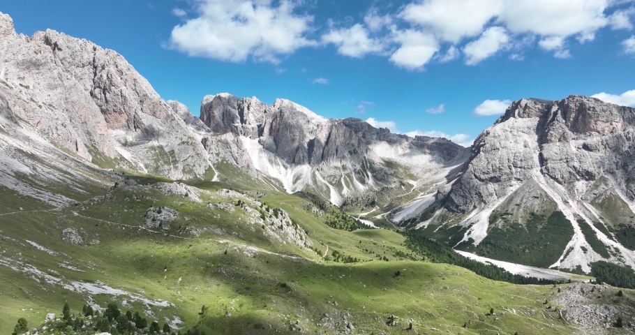 Dolomite Mountains, Dolomite Alps or Dolomitic Alps, are a mountain range located in northeastern Italy. Unesco world heritage. limestone alps grassland and cliff nature aerial drone overhead view.