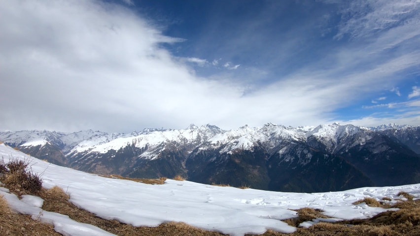 4K Time lapse of clouds above the snow covered peaks of the Himalayan mountain range during the winter season as seen from top of mountain at Manali in Himachal Pradesh, India. Timelapse of Himalayas. | Shutterstock HD Video #1094163649