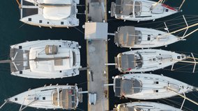 Aerial video of luxury yachts marina and sailing boats