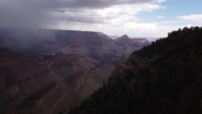 PAN SHOT - The South Rim of the Grand Canyon National Park, carved by the Colorado River in Arizona, USA. Unique natural geological formation. Grand Canyon before the storm.