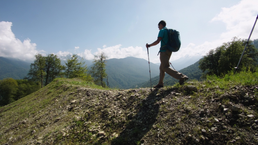 Senior students of geography are moving along mountain range in mountains of Caucasus. Return to base from training practice in alpine forest. Summer sports outdoor recreation Royalty-Free Stock Footage #1094175815