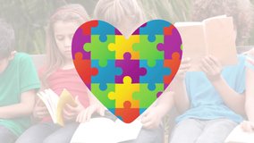 Animation of multi coloured puzzle elements forming heart Autism Awareness Month symbol with children reading books in the background. Autism awareness support concept digital composite. - Powered by Shutterstock - Get 15% off with code: PIKWIZARD15