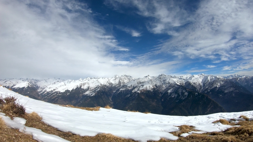 4K Time lapse of clouds above the snow covered peaks of the Himalayan mountain range during the winter season as seen from top of mountain at Manali in Himachal Pradesh, India. Timelapse of Himalayas. | Shutterstock HD Video #1094180755