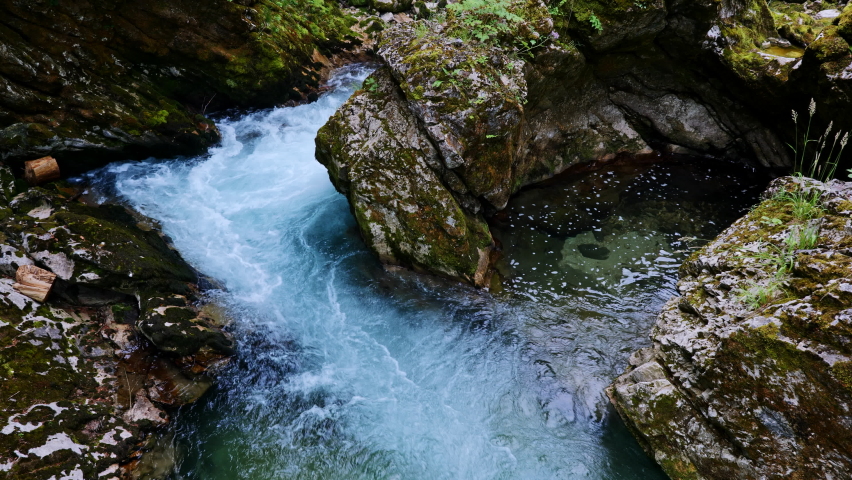 Rapid water flowing through rocks of Radovna mountain river in Vintgar Gorge, Triglav National Park, Slovenia. Royalty-Free Stock Footage #1094180891