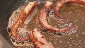 Close up video of preparing octopus in frying pan with butter