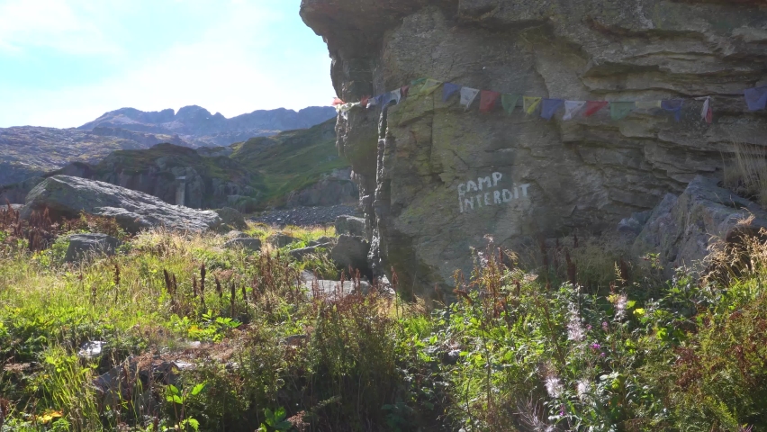 Mountain Camp with Flags Flapping in the Wind during a Warm Summer