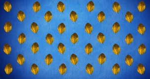 Animation of rows of autumn yellow leaves on blue background. autumn, fall, season, nature, pattern and colour concept digitally generated video.