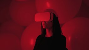 Portrait of woman wearing VR glasses in abstract space illuminated with red light. Girl in virtual or augmented reality helmet in dark atmosphere of cyberpunk - Powered by Shutterstock - Get 15% off with code: PIKWIZARD15