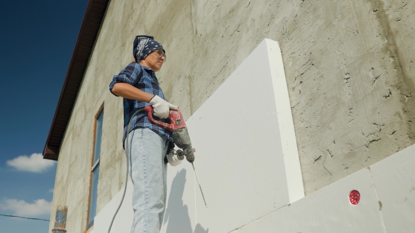 Insulation of the walls of the house with foam.