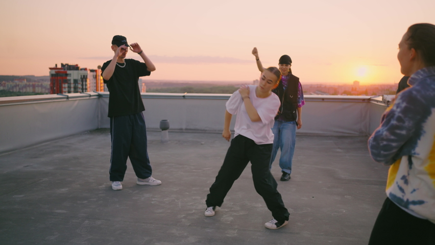 young dancers hang out on roof in summer sunset, pretty teen girl is breaking, portarit of b-girl